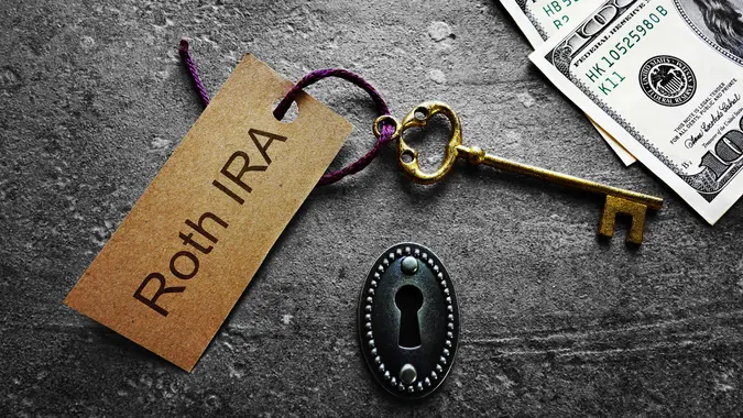Gold key with Roth IRA tag, with keyhole and cash.