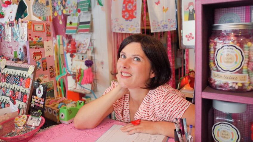 Young millennial female working in a cute stationary shop