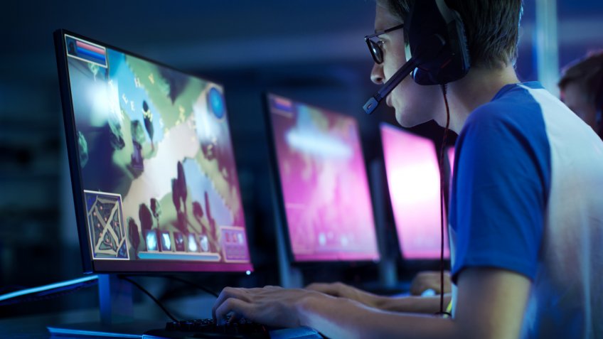 Stock, shares, NASDAQ, S&P 500, money, Man with earphones playing video games on computer