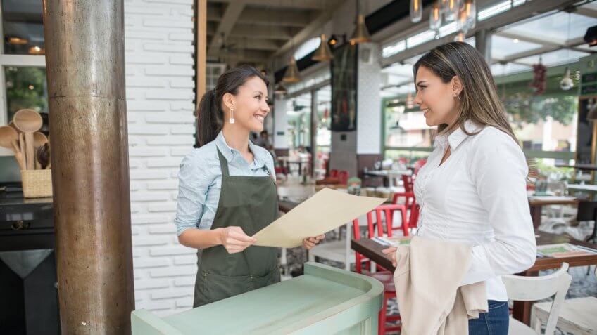 Friendly hostess working at a restaurant
