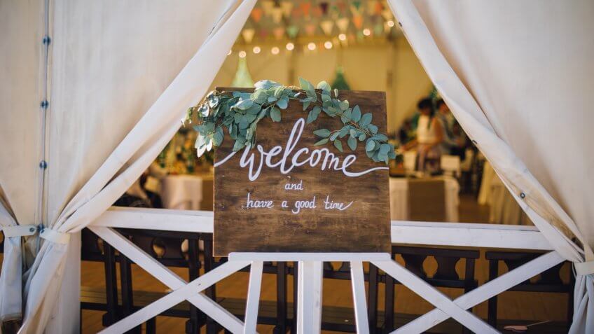 handmade wooden board with welcome sign on it