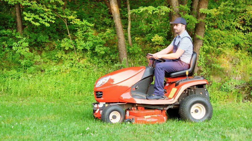 Lawn maintenance person mowing grass