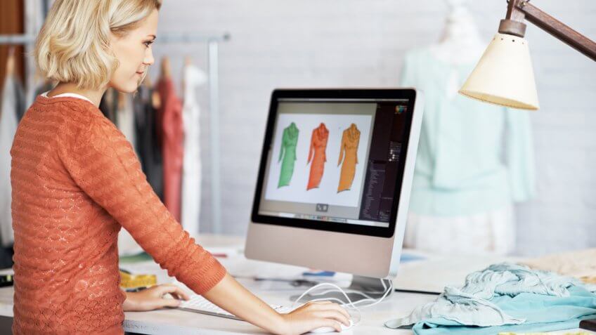Stock, shares, NASDAQ, S&P 500, money, A beautiful young fashion designer working on her computer.