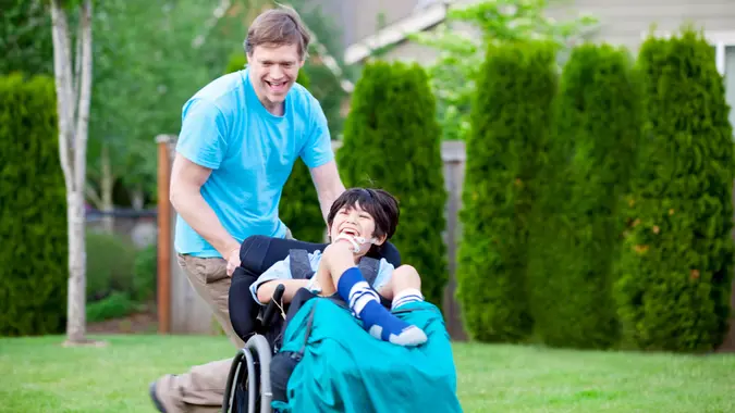 Father running with disabled son