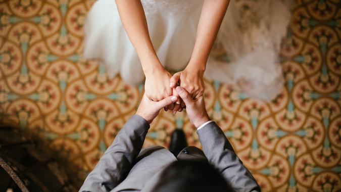 bride and groom holding hands