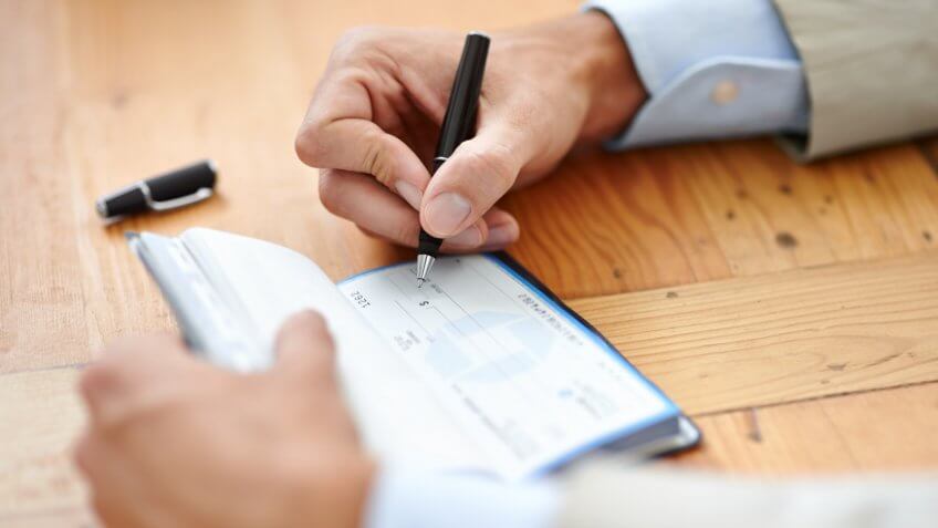 Cropped image of a businessman's hands around his piggybank, fees, America, money, payment, avoid fees, bills, debt