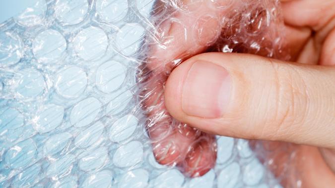 Man holding a piece of bubble wrap