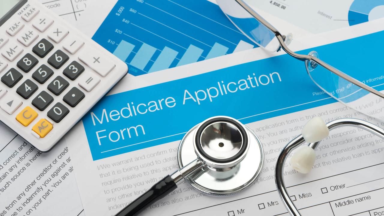 Medicare application form with stethoscope and paperwork