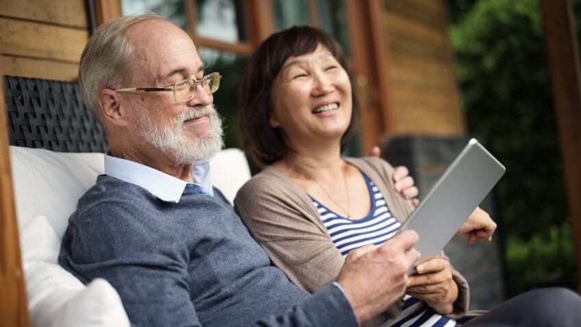 Senior couple relaxing on front porch