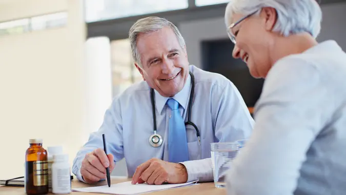 Doctor prescribing medicine to his senior patient