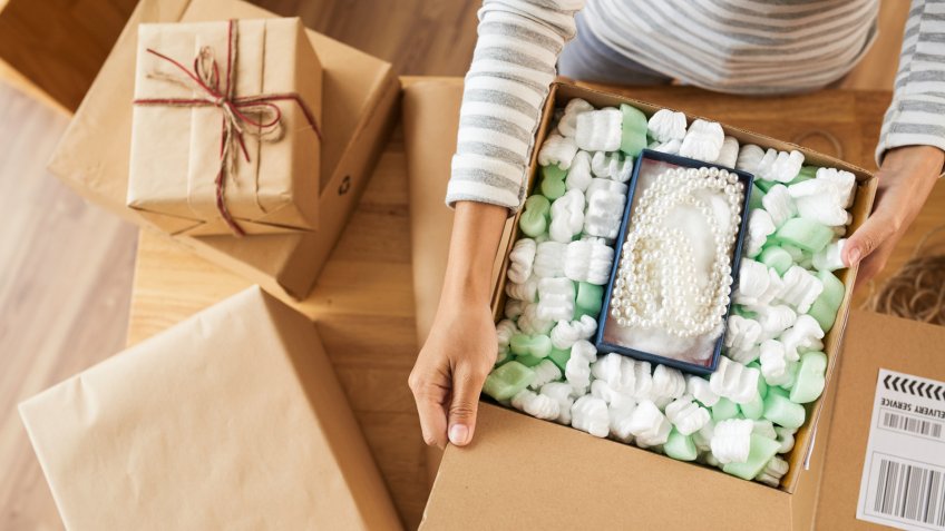 Woman opening many parcels she received, view from above, fees, America, money, payment, avoid fees, bills, debt