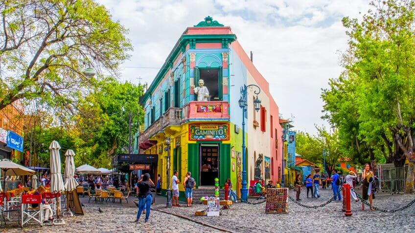 Buenos Aires, Argentina - April 15, 2015: The main square on of the Camanito in the La Boca neighborhood of Buenos Aires features brightly colored buildings and cobblestone streets that are a popular tourist destination.