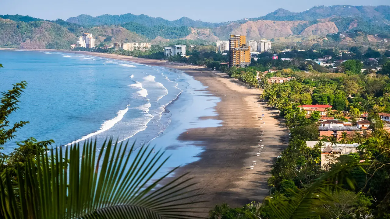 Tropical wide sandy beach of the town of Jaco, Costa Rica.