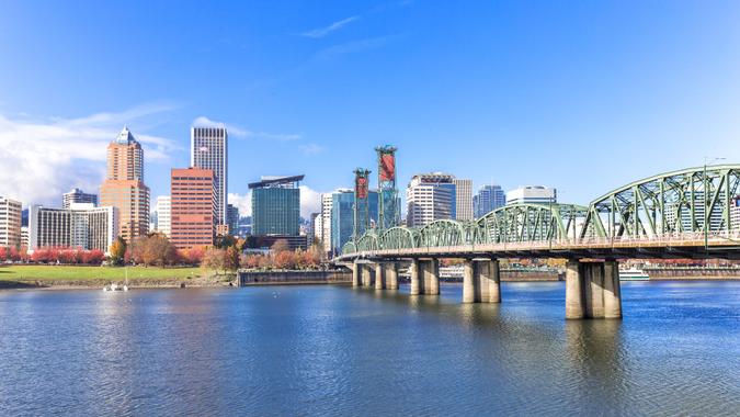 steel bridge over water with cityscape and skyline in portland.