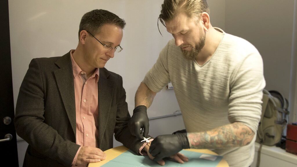 A picture made available on 04 March 2017 of David Holecek (L) getting a chip implanted in his hand by Jowan Osterlund (R) of the company Biohax, in Gothenburg, Sweden, 02 December 2015.