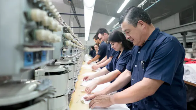 People operating machines at an embroidery factory