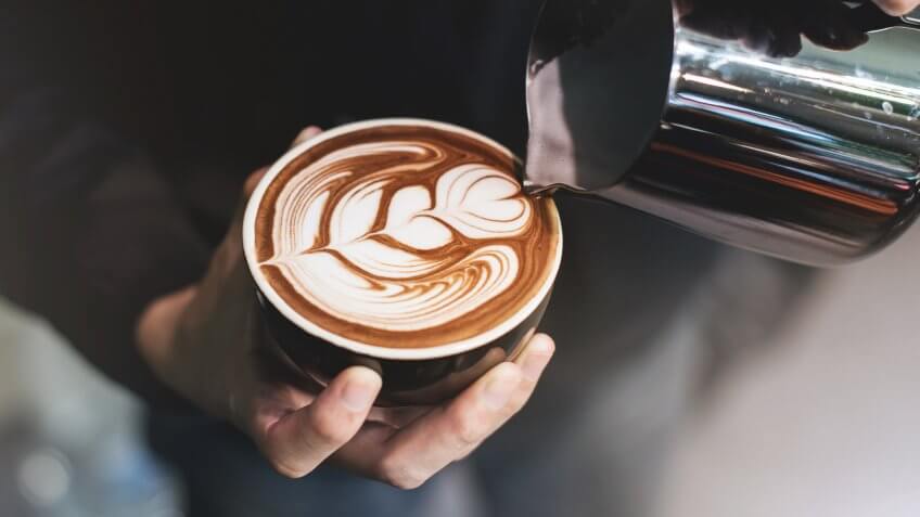 Barista make coffee cup latte art.
