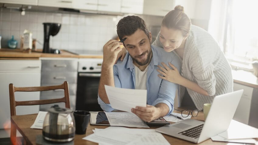 Photo of a young couple calculating home finances.