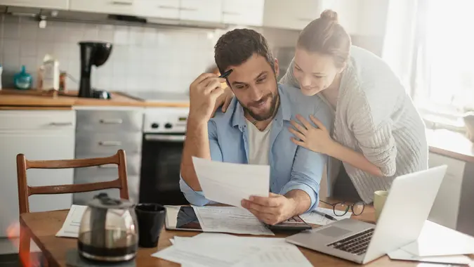 Photo of a young couple calculating home finances.