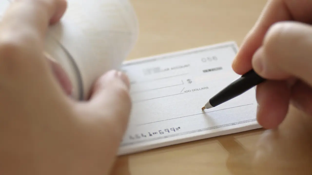 Businessman prepare writing check in the office.