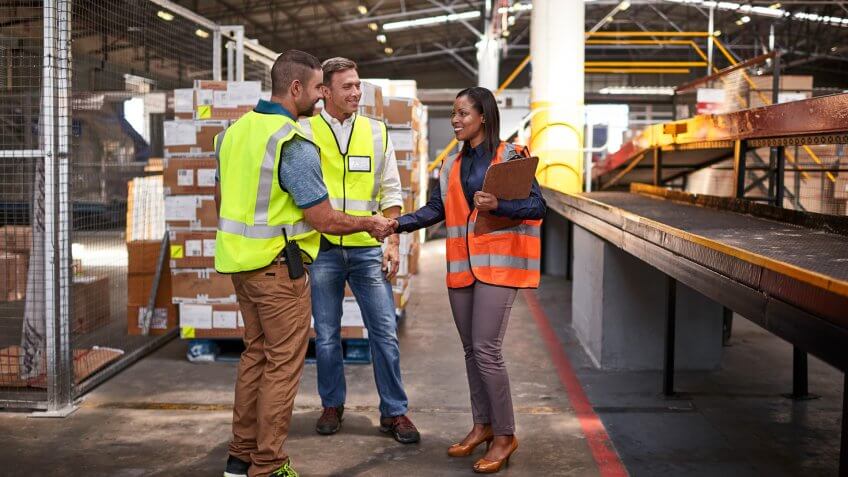two workers shaking hands