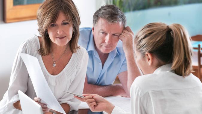 Worried mature Couple in Meeting With Advisor at home.