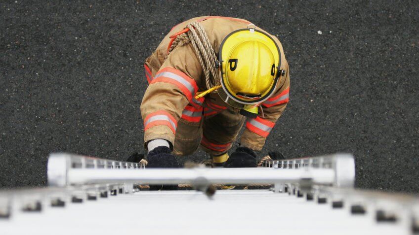 Top-down view of a fireman ascending a ladder.