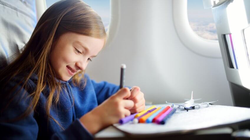 kid drawing in airplane seat