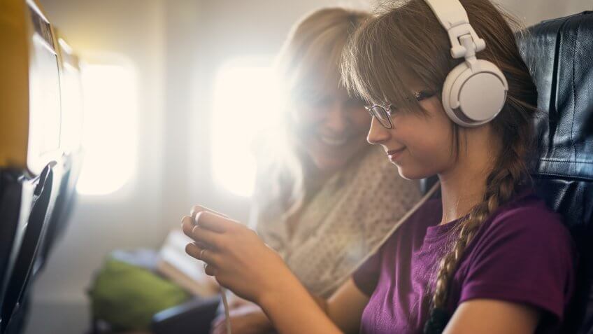 Mother and daughter travelling by plane.