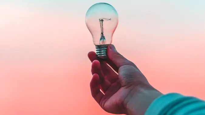 hand holding lightbulb.