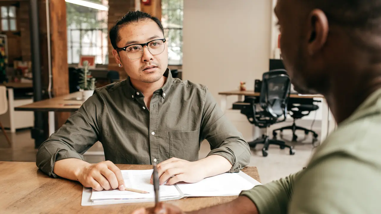 Two people talking at the office.