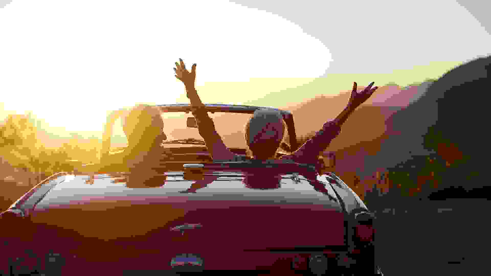 Shot of a joyful senior couple enjoying the sunset during a roadtrip.