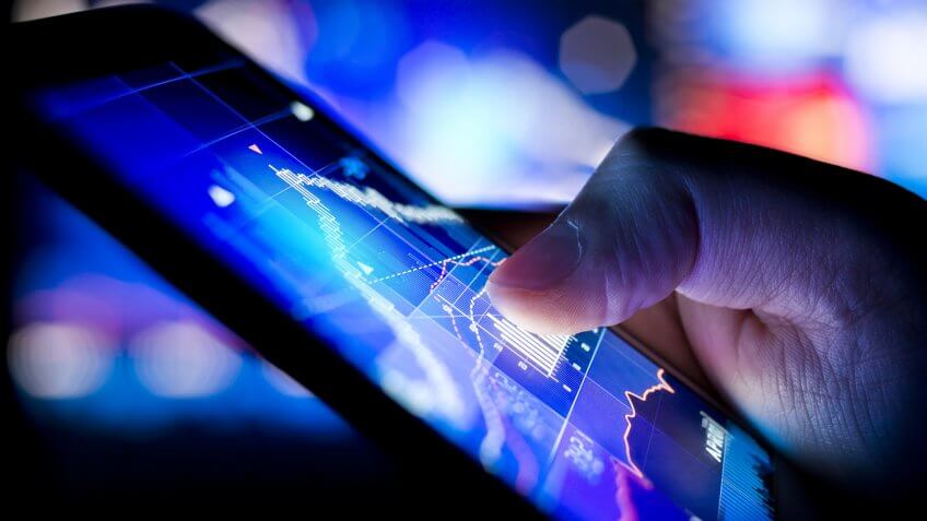 A person checking stock market data on a mobile device.