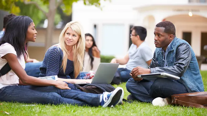 Group Of University Students Working Outside Together.