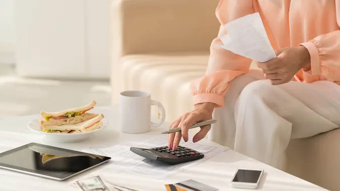 Woman making payments, budgeting, tending to personal finance and other money moves. stock photo
