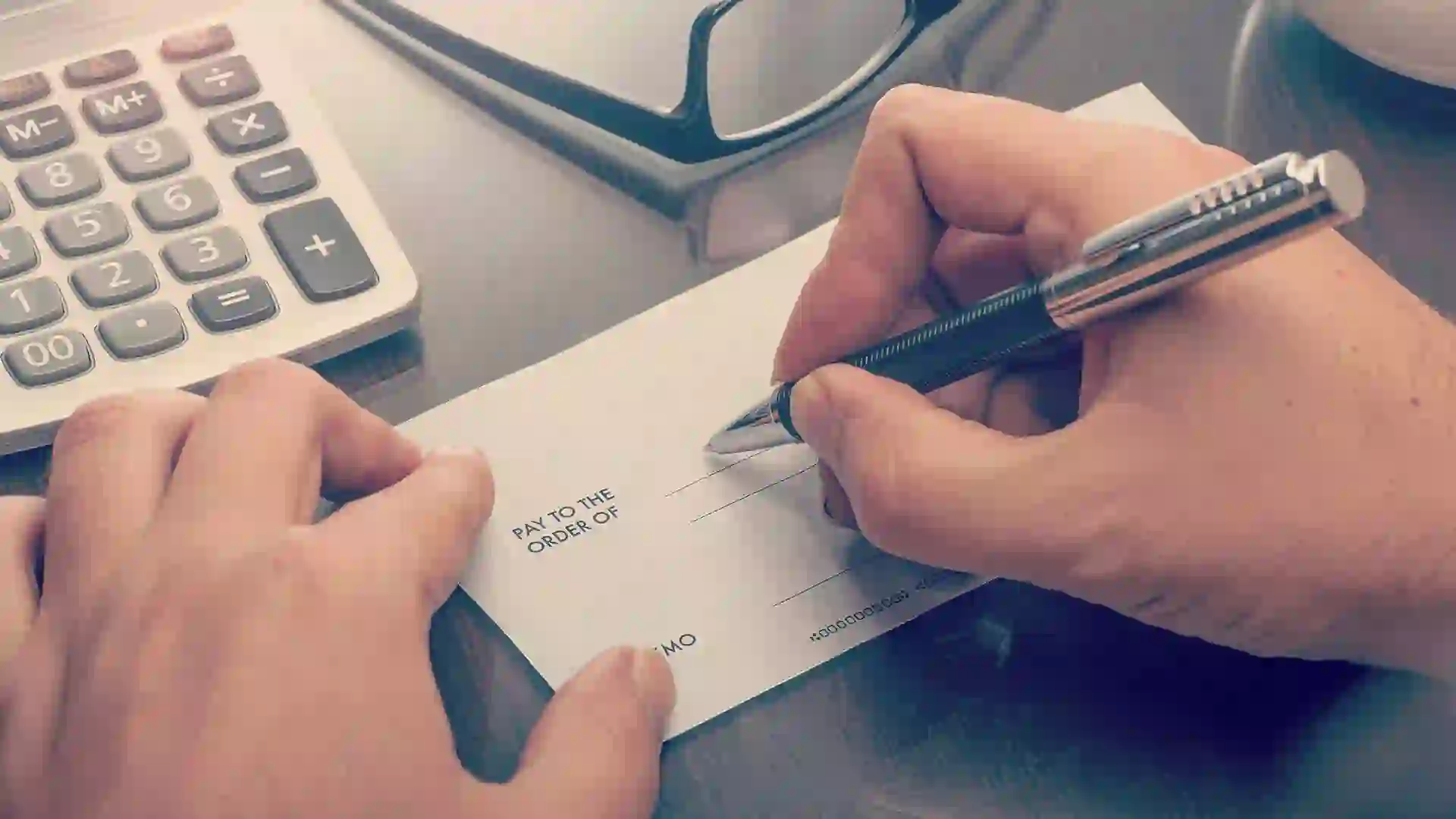 Man writing a payment check