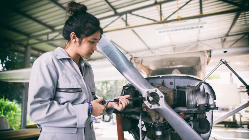 Asian women Engineers and technicians are repairing aircraft.
