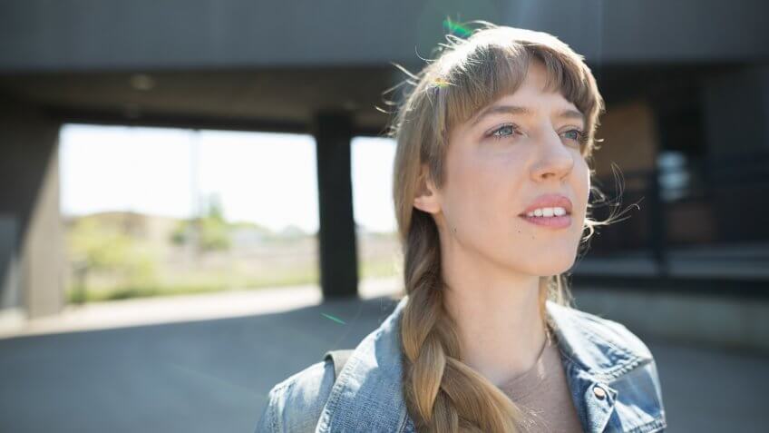 Pensive woman with braid looking away