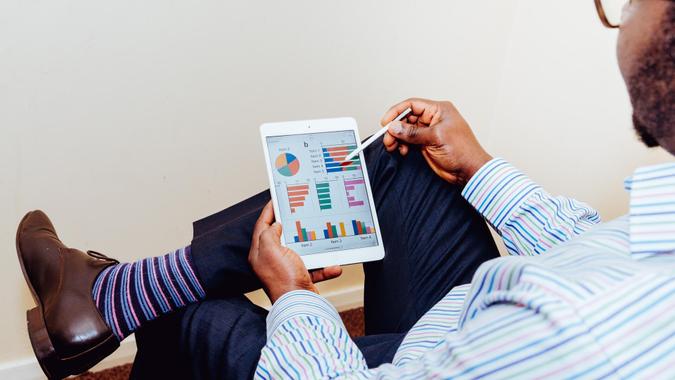 Man reviewing portfolio assets on a tablet