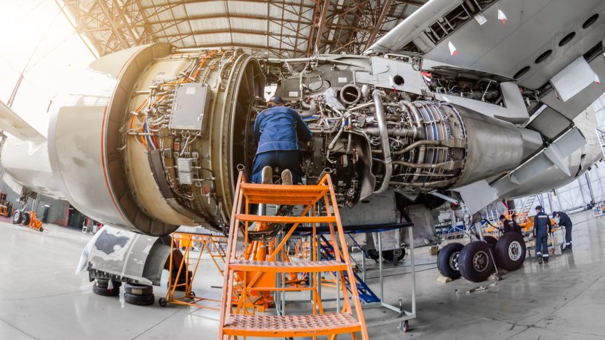 Fish eye shot of man working on an aircraft