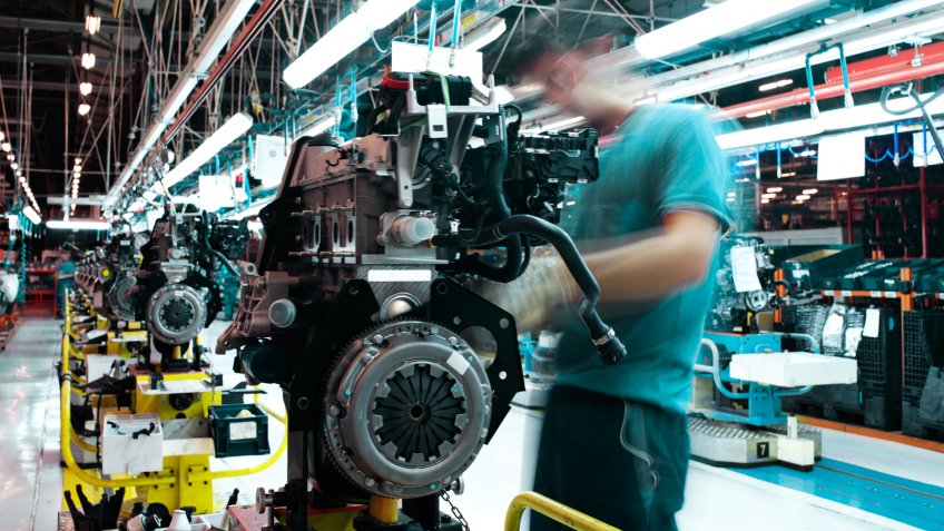 workman manufacturing in a car factory.