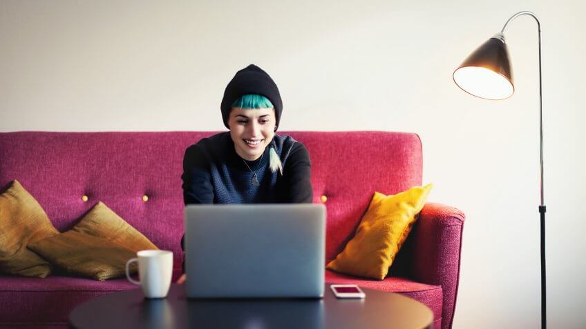 Young woman at home using laptop.
