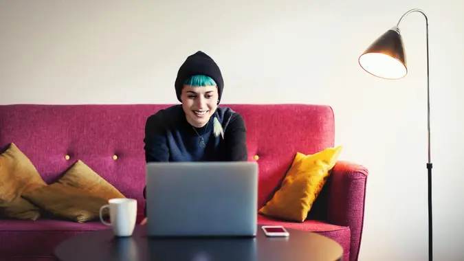 Young woman at home using laptop.