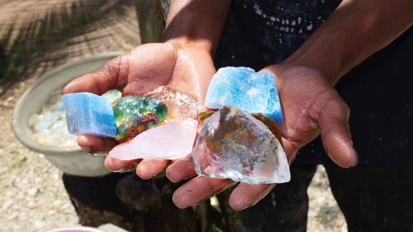 Hands holding various Precious Metals and Stones
