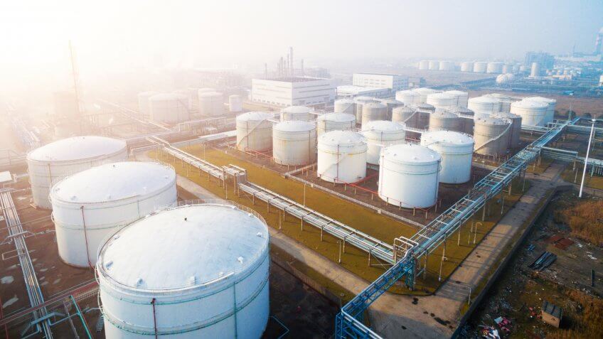 top view of white oil tank in modern refinery plant in blue sky.