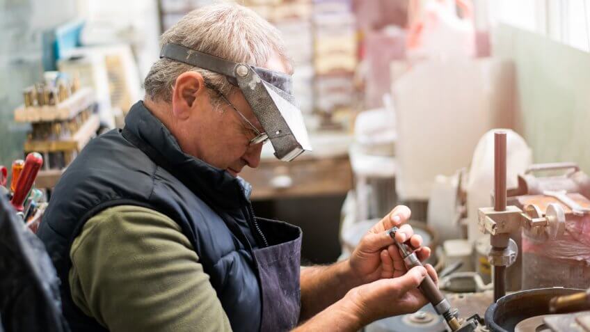 Man grinding a gemstone =