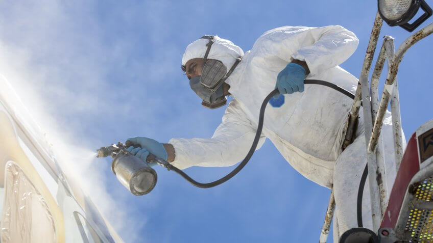 Man spraying paint on an aircraft