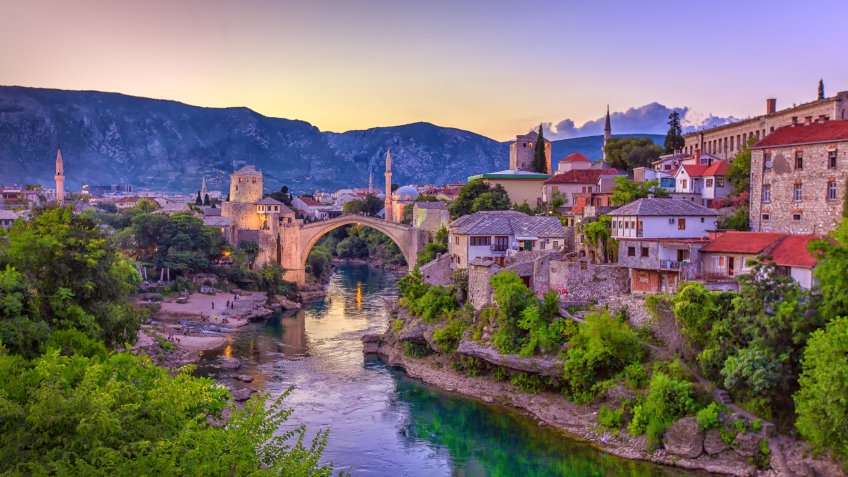 The Neretva river winding through the old UNESCO listed, Mostar bridge in Bosnia and Herzegovina.
