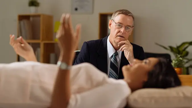 Psychiatrist listening to a patient speak about problems