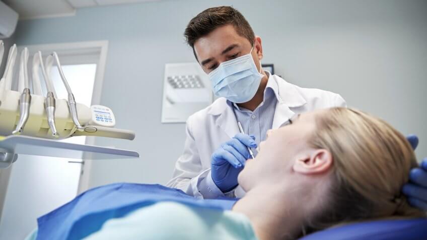 Dentist checking on teeth of a patient